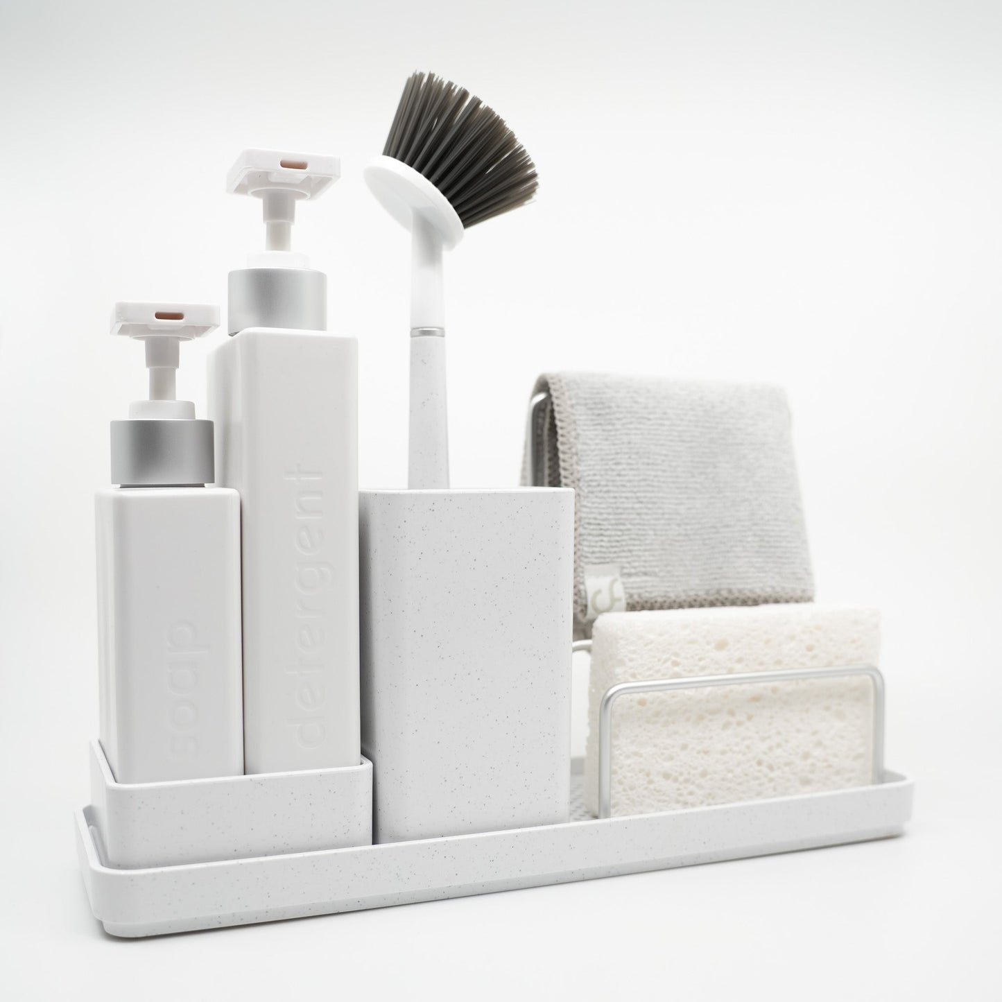 White cleaning caddy with various cleaning tools on a white background