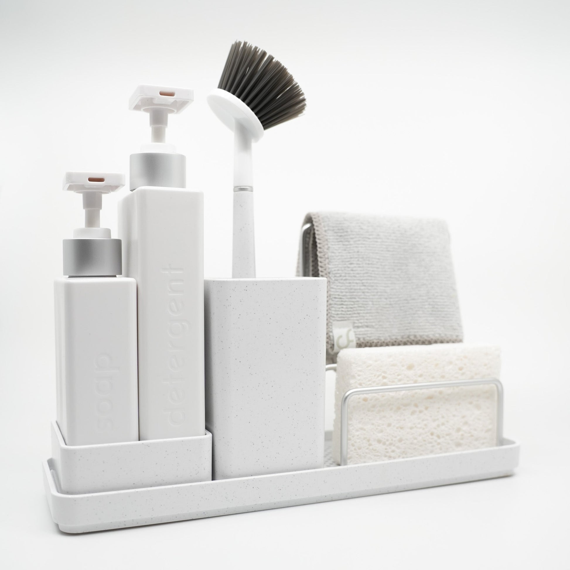 White cleaning caddy with various cleaning tools on a white background
